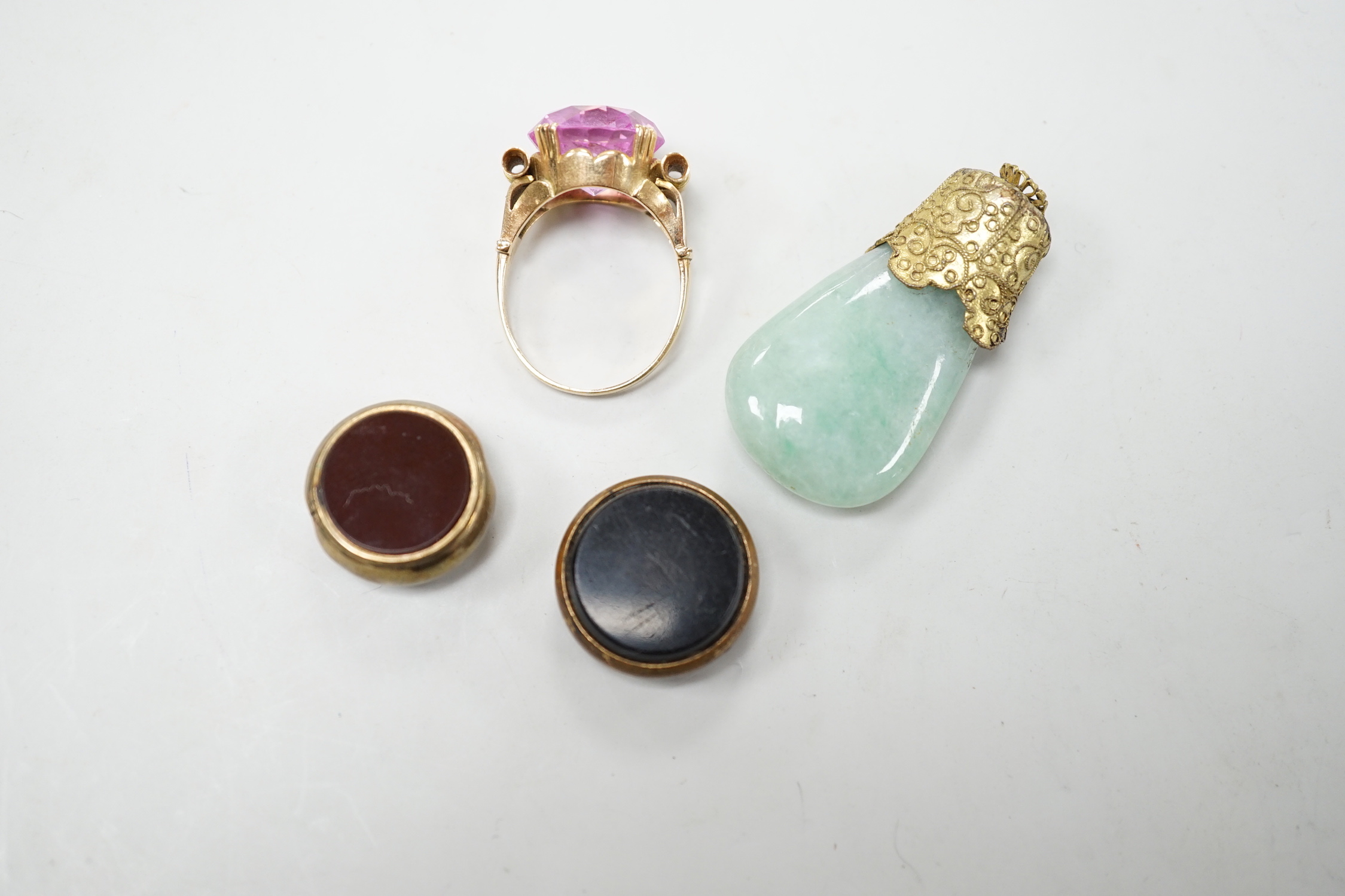 Two damaged carnelian set fobs and two other items including a yellow metal and pink stone ring.